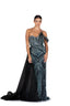 Woman wearing a black and silver beaded evening gown on a white background